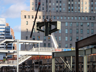 Columns A crane placing a hammerhead column base plate at the world Trade Center's new Transportation Hub